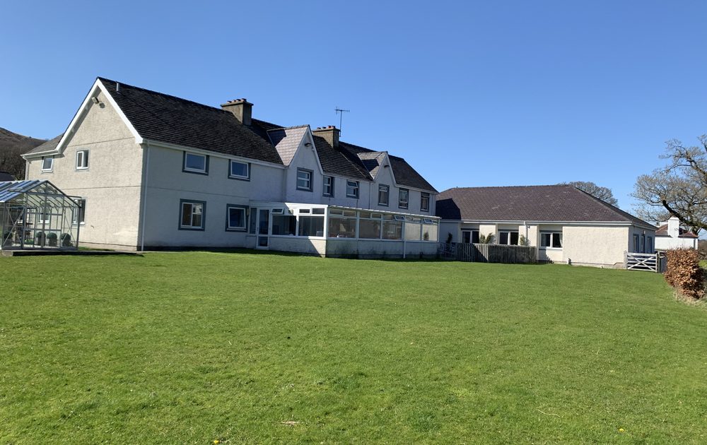 The rear of the home, conservatory and lawn